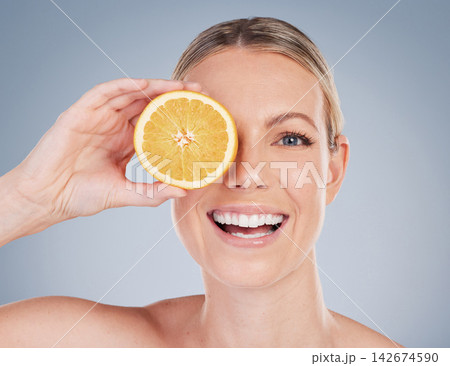 Skincare, orange fruit and portrait of woman in studio for facial treatment, natural glow or wellness on white background. Smile, beauty and hand of model for vitamin c, eco friendly or dermatology Skincare, orange fruit and portrait of woman in studio for facial treatment, natural glow or wellness on white background. Smile, beauty and hand of model for vitamin c, eco friendly or dermatology 142674590