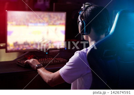 Gamer, computer screen and man with headphones, live stream and esports subscription from back. Content creator, influencer or streamer with headset for online challenge, video game or night at home. 142674591