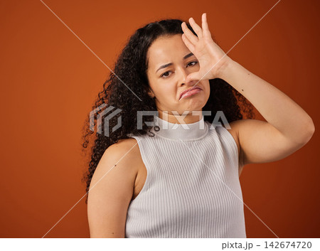 Funny, bad smell and portrait of woman in studio with silly facial expression for quirky emotion. Goofy, upset and female person from Colombia with unsure face for stink aroma by color background. Funny, bad smell and portrait of woman in studio with silly facial expression for quirky emotion. Goofy, upset and female person from Colombia with unsure face for stink aroma by color background. 142674720