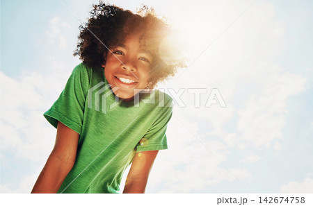 Portrait, black child and boy outdoor with smile for summer holiday, sunshine and childhood memories. Low angle, space and flare with happy kid for vacation, optimism and development on fun weekend. 142674758
