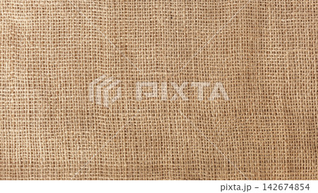 Coarse brown canvas background with a pronounced mesh structure 142674854