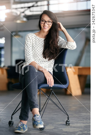 Portrait, smile and glasses for woman, chair and creative in office with desk, startup and confidence. New York, workplace and female employee in agency, proud and vision for business and career Portrait, smile and glasses for woman, chair and creative in office with desk, startup and confidence. New York, workplace and female employee in agency, proud and vision for business and career 142675347