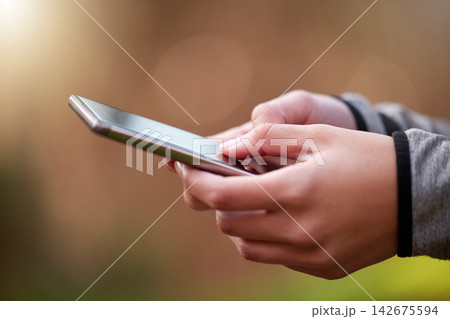 Outdoor, hands and smartphone with typing, woman and internet with social media, check progress and digital app. Person, athlete and runner in park, cellphone and mobile user with network and contact 142675594