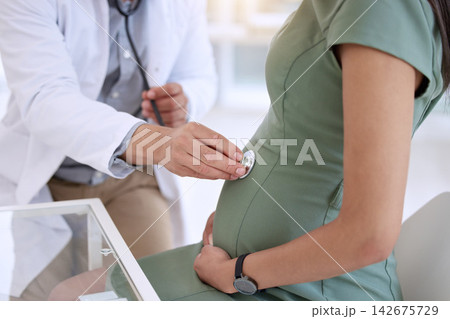 Doctor, man and pregnant woman in hospital for consultation, healthcare checkup and stethoscope audio. Male obstetrician, pregnancy update and patient by desk for listen to stomach and medical exam Doctor, man and pregnant woman in hospital for consultation, healthcare checkup and stethoscope audio. Male obstetrician, pregnancy update and patient by desk for listen to stomach and medical exam 142675729