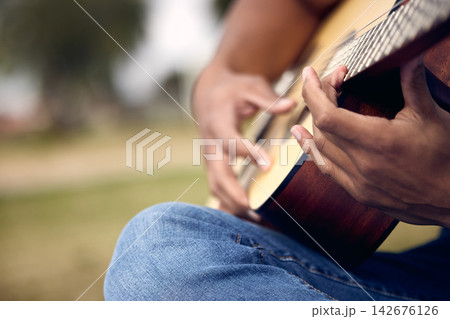 Guitar, hands and musician in garden for music, sound and song or performance in nature. Male person, instrument and artist in backyard for practice, production and show rehearsal for band on weekend 142676126