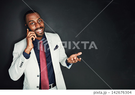 Business, black man and smile on phone call in studio on dark background with connection, networking and conversation. Portrait, corporate and happy with good news for promotion or career growth Business, black man and smile on phone call in studio on dark background with connection, networking and conversation. Portrait, corporate and happy with good news for promotion or career growth 142676304
