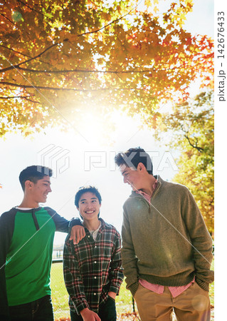 Happy, boys or friends in park together for summer holiday, school break or support. Smiling, young men or group of teenagers walking in forest for talking, connection and outdoor adventure in sun 142676433