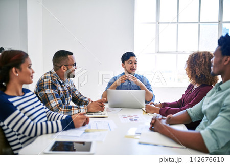 Startup, laptop or people in meeting speaking of paperwork, feedback review or partnership together. Development, staff or designers talking for teamwork or planning in conversation for project brief 142676610