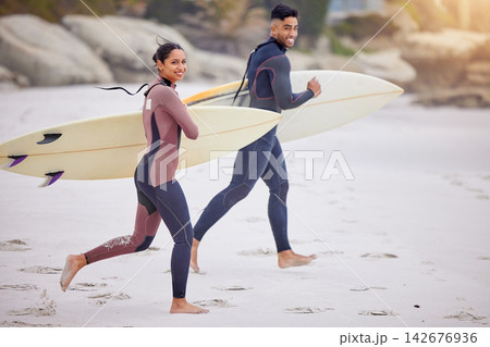 Portrait, surfboard and couple on beach running for water sports, tropical holiday fun and travel adventure together. Smile, man and woman at ocean for surfing, island vacation and bonding in Hawaii. 142676936