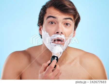 Portrait, surprise and man with shaving cream brush in studio for hair removal, hygiene or grooming isolated on blue background. Face, beard and model apply foam for skincare, beauty and wellness Portrait, surprise and man with shaving cream brush in studio for hair removal, hygiene or grooming isolated on blue background. Face, beard and model apply foam for skincare, beauty and wellness 142677683