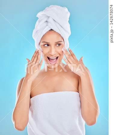 Woman, smile and cream for skincare in studio on blue background with routine, ingredients and satisfied for results. Wow, natural and happy in confidence with facial treatment and skin lotion 142678074