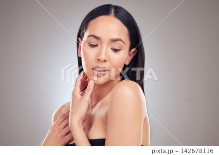 Beauty, skincare and woman in studio for cosmetics, treatment and touch face on grey background. Hands, wellness and female model for natural glow, satisfaction or aesthetic with mockup space 142678116