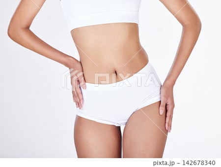 Closeup, body and woman with underwear, wellness and fitness on white studio background. Person, girl and model with panty, nutrition and exercise with gut health, beauty and workout with training 142678340