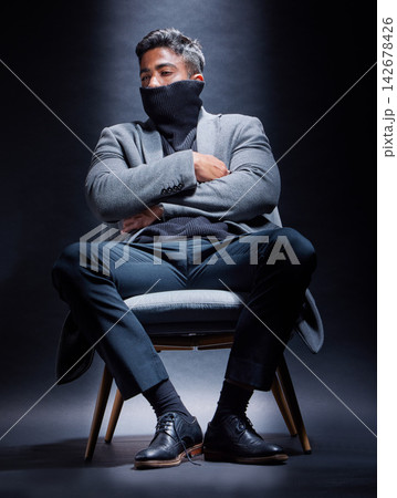Gangster, criminal and man with fashion in chair on studio, dark background or thinking of power. Serious, person and cool style with mask on face with mob secret, danger or character in mafia crime Gangster, criminal and man with fashion in chair on studio, dark background or thinking of power. Serious, person and cool style with mask on face with mob secret, danger or character in mafia crime 142678426