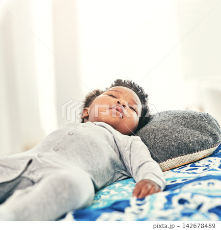 Infant, sleeping and black child on bed in nursery room for resting, tired or development. Baby, relax and sweet newborn kid lying in bedroom for comfortable, morning nap or dreaming in home 142678489