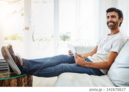 Thinking, man and tablet on sofa for networking, chat and online conversation at home. Living room, male chatter and mobile app for streaming movies, games and social media with technology to relax Thinking, man and tablet on sofa for networking, chat and online conversation at home. Living room, male chatter and mobile app for streaming movies, games and social media with technology to relax 142678627
