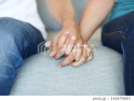 Couple, love and holding hands for trust, care and solidarity or romance in home. Compassion, partnership and support with affection for people in relationship, marriage and therapy for mental health Couple, love and holding hands for trust, care and solidarity or romance in home. Compassion, partnership and support with affection for people in relationship, marriage and therapy for mental health 142679065