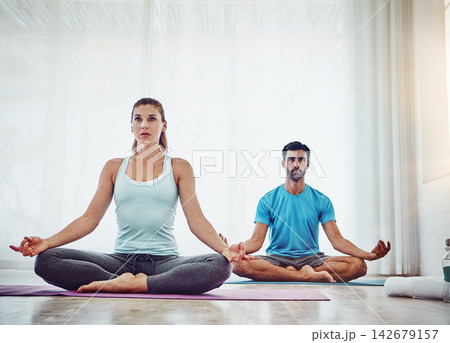 Spiritual, meditation and couple in home for healing, wellness and workout in living room. Fitness, mental health and yogi woman with man for pilates exercise, balanced chi or lotus energy or aura Spiritual, meditation and couple in home for healing, wellness and workout in living room. Fitness, mental health and yogi woman with man for pilates exercise, balanced chi or lotus energy or aura 142679157
