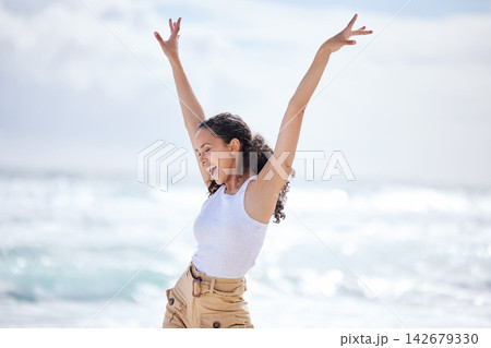 Woman, excited and dancing on beach with freedom for adventure, celebration and summer vacation on mockup. Person, happy and carefree with energy for holiday fun, enjoyment and entertainment by ocean Woman, excited and dancing on beach with freedom for adventure, celebration and summer vacation on mockup. Person, happy and carefree with energy for holiday fun, enjoyment and entertainment by ocean 142679330