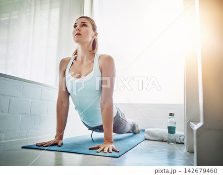 Home, woman and stretching with fitness, wellness and routine with endurance, flexible and workout. Person, apartment and girl on yoga mat, training and healthy with progress, breathing and exercise 142679460