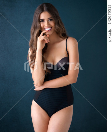 Woman, smile portrait and studio with lingerie, underwear and confident female person for body positivity. Model, shape wear and feminine bodysuit for comfort, happy and proud on dark background 142679513