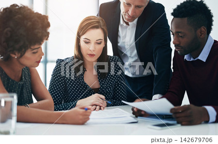 Lawyer, group and paperwork at meeting with people, reading and thinking for problem solving at legal agency. Team, men and women by documents, review and talk for investigation at corporate law firm 142679706