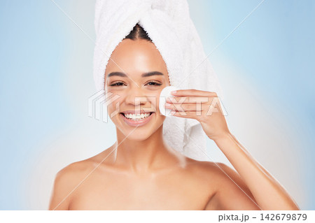 Young woman, portrait and smile with cotton cleaning face in studio background for skincare, cosmetics and beauty. Female person, dermatology or grooming fresh for wellness, hygiene and anti aging 142679879