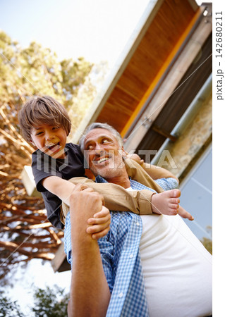 Grandfather, playing and happy child on grass at family house with embrace, bonding and love with care in garden..Grandpa, people and kid on shoulders in outdoors on vacation with nature for memory 142680211