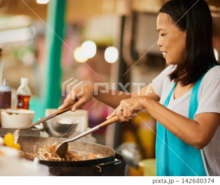 Woman, takeaway market and cooking with Thai dish, vendor of prepare meal with utensils, ingredients or informal business. Traditional, street chef or entrepreneur with culture, food or fried cuisine Woman, takeaway market and cooking with Thai dish, vendor of prepare meal with utensils, ingredients or informal business. Traditional, street chef or entrepreneur with culture, food or fried cuisine 142680374