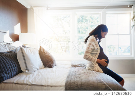 Bedroom, excited and pregnant woman with happiness, relax and healthy with fertility, wellness and stomach. Person, home and girl with pregnancy, motherhood and sunshine with maternity leave and ivf 142680630