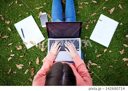 Student, laptop and notebook on grass for learning, research and studying on campus. Woman, computer and typing outdoors at university for elearning, networking and online education from above 142680714