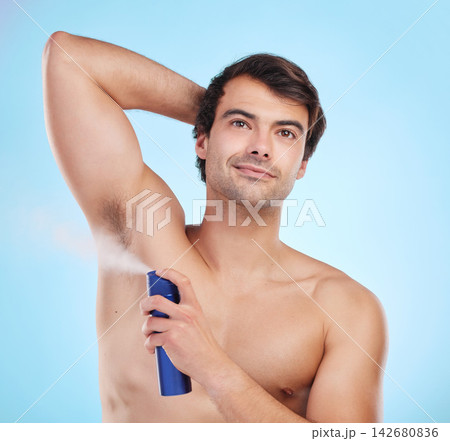 Grooming, man and deodorant in morning, routine and wellness in body care, hygiene and blue background. Male person, cosmetics and fresh for confidence, masculine and fragrance with product in studio 142680836