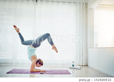 Yoga, woman and handstand on floor for fitness in home with balance, flexibility and arm strength. Pilates, yogi and exercise for strong core, wellness and healthy body with morning routine in lounge 142680918
