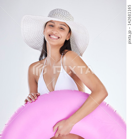 Portrait, smile and woman with bikini, hat and toy for beach fun on white studio background. Face, person and model with happiness, cheerful and girl with vacation, holiday and joy with weekend break Portrait, smile and woman with bikini, hat and toy for beach fun on white studio background. Face, person and model with happiness, cheerful and girl with vacation, holiday and joy with weekend break 142681165