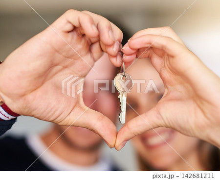 Portrait, couple and keys for new home, heart hands and real estate with love, support and trust. Closeup, man and woman with care emoji, lock for security and symbol for kindness, house and mortgage 142681211