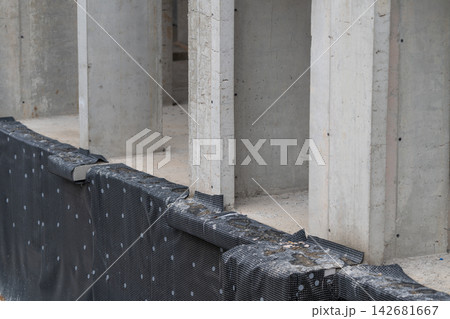 Construction site showcasing concrete pillars against a backdrop of preparation for a new building project Construction site showcasing concrete pillars against a backdrop of preparation for a new building project 142681667