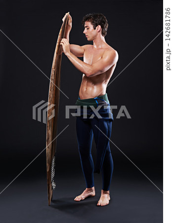 Studio, surfboard and male athlete in swimsuit, board and wooden isolated on black background. Body, wetsuit and water sports for hobby and fitness for man model person, equipment or wax for training Studio, surfboard and male athlete in swimsuit, board and wooden isolated on black background. Body, wetsuit and water sports for hobby and fitness for man model person, equipment or wax for training 142681786