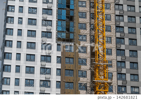Modern construction site showcasing sleek architecture and a vibrant crane against a clear blue sky Modern construction site showcasing sleek architecture and a vibrant crane against a clear blue sky 142681821