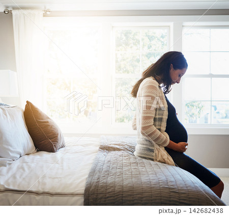 Home, excited and pregnant woman with sunshine, relax and rest with fertility, stomach and belly. Person, bedroom and girl with pregnancy, motherhood and joy with maternity leave, wellness and health 142682438