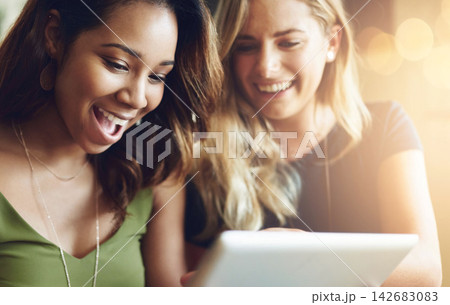 Laugh, friends and women in coffee shop with tablet for social media, funny meme or networking together. Communication, smile and girl in cafe with online post, happiness or connection on digital app Laugh, friends and women in coffee shop with tablet for social media, funny meme or networking together. Communication, smile and girl in cafe with online post, happiness or connection on digital app 142683083