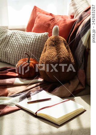 Cozy Autumn Scene With Pumpkins Blankets Notebook And Pen For Seasonal Themes Cozy Autumn Scene With Pumpkins Blankets Notebook And Pen For Seasonal Themes 142683287