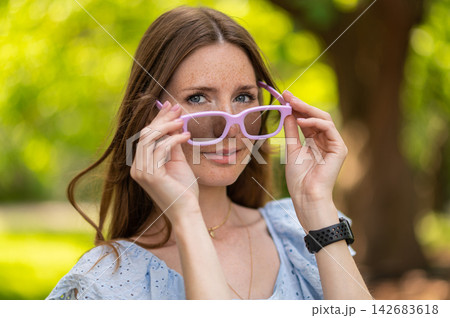 Young woman in light dress looking happy and joyful Young woman in light dress looking happy and joyful 142683618