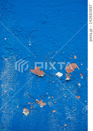 Weathered blue wall with peeling paint texture and rustic surface detail Weathered blue wall with peeling paint texture and rustic surface detail 142683897