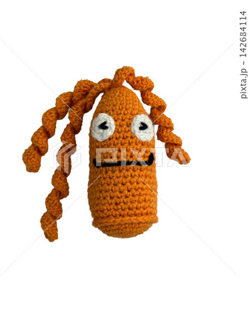 Cute handmade orange crochet creature doll isolated on white background Cute handmade orange crochet creature doll isolated on white background 142684114