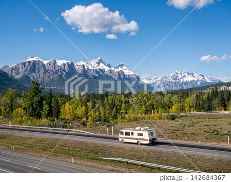 car on the road in mountains 142684367