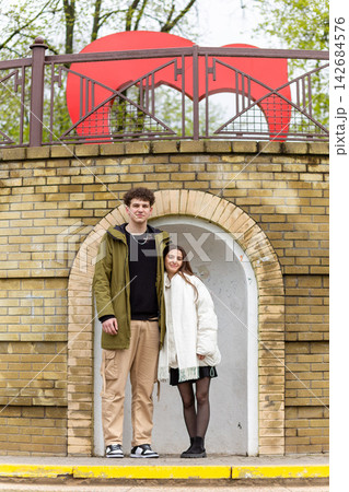 Young couple sharing a tender moment under a brick archway Young couple sharing a tender moment under a brick archway 142684576