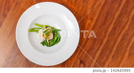 Gourmet Fish Dish on White Plate with Greens and Copy Space 142685995
