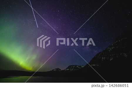 Aurora Borealis and Milky Way Over Mountain Lake at Night 142686051