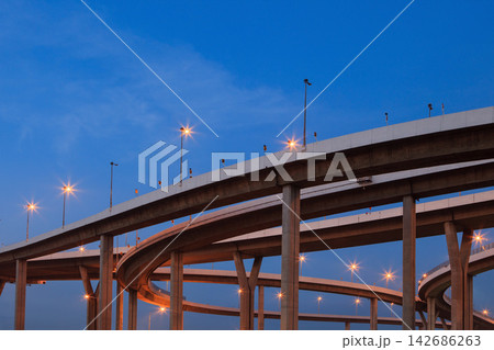 Urban Highway Interchange at Blue Hour with Glowing Streetlights 142686263