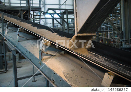 Industrial Conveyor Belt Moving Powder in Manufacturing Plant Industrial Conveyor Belt Moving Powder in Manufacturing Plant 142686287